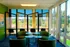 Bright and inviting seating area with modern chairs and expansive windows offering serene outdoor views, ideal for relaxation or casual meetings.