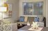Chic living room with modern decor featuring patterned cushions, abstract art, and a stylish geometric centerpiece.