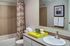 Elegant bathroom with a stylish chevron shower curtain, modern sink, and decorative art piece, offering a refreshing and contemporary atmosphere.