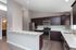 Modern kitchen with sleek stainless steel appliances, elegant dark wood cabinets, and expansive countertops, offering a stylish and functional space for cooking.