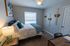 Inviting bedroom with cozy lighting, stylish decor, and a plush bed showcasing elegant throw pillows and a knit blanket, perfect for relaxation.