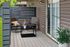 Charming patio with elegant outdoor seating, vibrant plants, and modern lighting, perfect for relaxing in style.