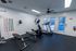 Modern fitness room with top-notch equipment, including treadmill, exercise bike, and bench, perfect for a healthy lifestyle.