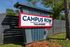 Campus Row entrance sign in Tallahassee with modern design and vibrant colors under a clear blue sky.