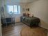 Tranquil bedroom with natural light, chic decor, and cozy desk space perfect for productivity.