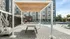 Inviting outdoor area with stylish poolside seating under a chic pergola, offering a luxurious living experience.