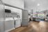 Modern open-concept kitchen and living space with premium appliances, cozy seating area, and in-unit laundry for ultimate convenience.