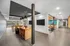 Modern communal lounge with sleek design featuring a foosball table, cozy seating area, and ambient lighting perfect for relaxation and social gatherings.