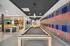 Vibrant recreation room with a sleek billiards table, modern lounge area, and colorful wall art, ideal for social gatherings and entertainment.