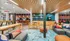 Vibrant community lounge featuring modern seating, colorful decor, and a stylish beverage station.