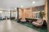 Modern lobby area featuring cozy seating, elegant wood paneling, and stylish decor for an inviting atmosphere.