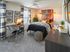 Bright and modern bedroom with stylish decor, featuring a cozy bed, chic desk setup, and vibrant wall art.