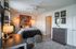Chic bedroom with modern decor, featuring a cozy bed, stylish artwork, and a serene ambiance.