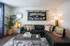 Charming living room with cozy sectional sofa, vibrant pillows, and welcoming 'The Roost' banner, complemented by stylish decor and soothing lighting.