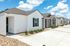 Charming row of modern bungalows with sleek designs, set against a bright blue sky, perfect for comfortable and stylish living.