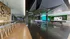 Modern recreational area featuring stylish seating, ping pong tables, and vibrant wall art with greenery accents for a lively atmosphere.