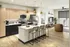 Modern open-concept kitchen and living room with sleek finishes, inviting island seating, and stylish lighting, perfect for entertaining.