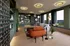 Modern open-concept living room with vibrant decor and stunning countryside views through floor-to-ceiling windows.