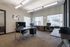 Contemporary office space with modern furnishings, large windows, and abundant natural light.
