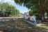 Inviting entrance to a charming apartment complex, surrounded by lush green trees and a welcoming sign.
