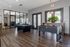 Inviting recreation room with sleek foosball and pool tables, stylish lighting, and modern decor, perfect for entertainment and relaxation.