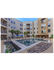 Elegant apartment complex courtyard featuring a pristine swimming pool, lush palm trees, and comfortable lounging chairs, perfect for relaxation and leisure.