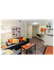 Cozy and modern living area with stylish decor, featuring a sleek sofa, vibrant cushions, and an inviting open-plan kitchen layout.
