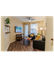 Charming living room with modern decor, featuring a cozy sofa, vibrant cushions, and natural light from French doors.