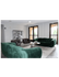 Elegant living room with modern green velvet sofas, stylish armchairs, and chic decor, offering a spacious and inviting atmosphere.