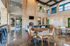 Luxurious open-concept common area with polished floors, modern seating, and stylish stone accents, featuring a view into a state-of-the-art fitness center.