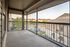 Inviting screened balcony with scenic views, perfect for relaxation in a serene apartment setting.