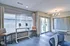 Modern and inviting communal area with sleek computer workstations, plush seating, and abundant natural light from large windows.