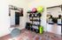 Modern home gym with fitness equipment including kettlebells, exercise balls, and a smart fitness mirror.