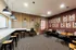 Modern workspace lounge featuring stylish seating, motivational wall art, and ambient lighting.