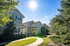 Charming suburban homes under a bright, sunny sky with lush green landscaping and inviting walkways.