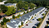 Modern townhouse community with neatly arranged homes, ample parking, and lush greenery, perfect for vibrant suburban living.