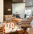 Modern common area featuring a cozy seating arrangement with a foosball table and a stylish industrial design, perfect for social gatherings.
