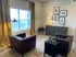 Charming living room with stylish leather armchairs, elegant mustard curtains, and chic decor pieces on a rustic sideboard, offering a cozy and inviting atmosphere.