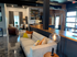 Modern open-concept living area with stylish decor, cozy seating, and chic lighting in a well-lit apartment.