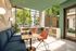 Modern lounge area featuring cozy seating, large windows with lush greenery views, and stylish decor for a vibrant atmosphere.