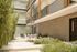 Luxurious apartment courtyard featuring modern outdoor seating, lush bamboo, and elegant string lighting, perfect for relaxing and entertaining.