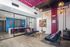 Modern lounge area with colorful seating, vibrant artwork, and stylish lighting, perfect for welcoming guests.