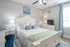 Cozy bedroom with elegant decor, featuring a plush bed with floral accents, stylish nightstands, and a tasteful wall-mounted antler decoration.
