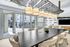 Modern meeting space with elegant lighting, large table, and plush seating looking out to a charming terrace.