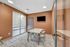 Modern conference room with stylish decor, featuring an elegant table, chic chairs, and a sleek wall-mounted TV.