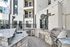 Modern apartment courtyard with luxurious outdoor kitchen, featuring granite countertops and stainless steel grill.
