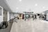Bright and spacious fitness center featuring modern gym equipment, sleek flooring, and a stylish design.