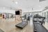 Modern fitness center with state-of-the-art cardio and strength training equipment, featuring bright natural lighting and stylish decor.