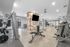 Modern fitness center with state-of-the-art gym equipment, featuring sleek design and ample natural light.