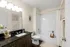 Elegant bathroom with modern fixtures, sleek black countertop, and decorative floral accents for a luxurious feel.